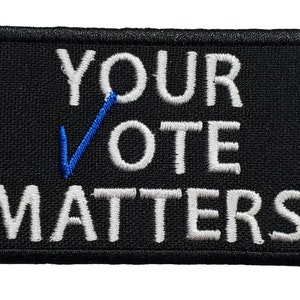May include: Black embroidered patch with white text that reads "YOUR VOTE MATTERS" and a blue checkmark.