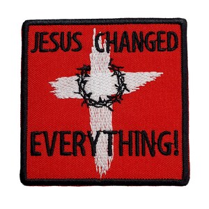 May include: Red embroidered patch with a white cross and a crown of thorns. The text "JESUS CHANGED EVERYTHING!" is embroidered in black.