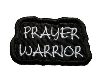May include: Black embroidered patch with white stitching that reads "PRAYER WARRIOR".