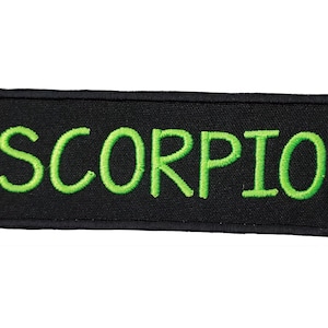May include: Black embroidered patch with green lettering that reads "SCORPIO".