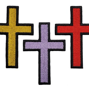 May include: Three embroidered crosses, one yellow, one red, and one purple.