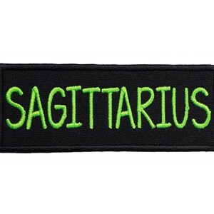 May include: Black embroidered patch with the word "SAGITTARIUS" in green lettering.