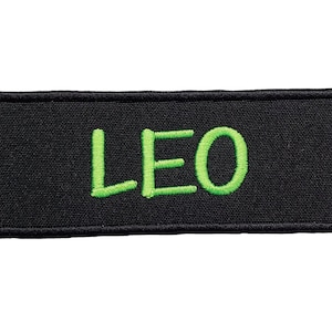 May include: Black fabric patch with the name "LEO" embroidered in green.