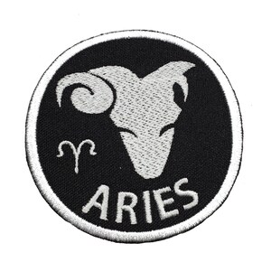 May include: White embroidered Aries zodiac sign patch on a black background. The patch is circular and has a white border.