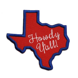 May include: Red felt outline of the state of Texas with a blue embroidered border. The text "Howdy Y'all!" is embroidered in white on the red felt.