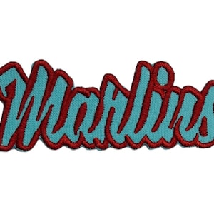May include: An embroidered patch featuring the word "Marlins" in a stylised font, with blue and red stitching.