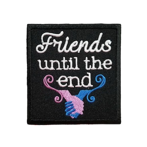 May include: Black embroidered patch with white text that reads "Friends until the end". The patch features a pink and blue hand shake with swirls.