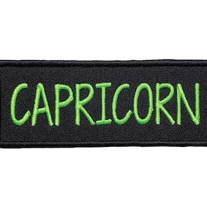 May include: Black embroidered patch with the word "CAPRICORN" in green thread.