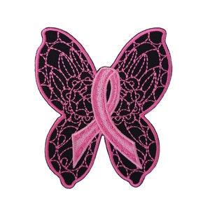 May include: Pink ribbon in the shape of a butterfly, embroidered on a black fabric patch.