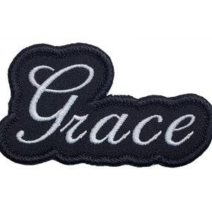 May include: Black embroidered patch with the word "Grace" in white cursive lettering.