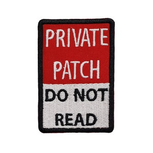 May include: A red and white embroidered patch with black stitching. The patch reads "PRIVATE PATCH DO NOT READ".
