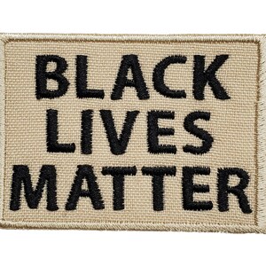 May include: Beige fabric patch with black embroidered text that reads "Black Lives Matter".