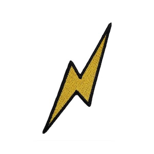 May include: A yellow lightning bolt with a black outline. The bolt is a simple design with a sharp point.