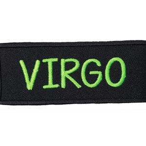 May include: Black fabric patch with green embroidered text that reads "VIRGO".