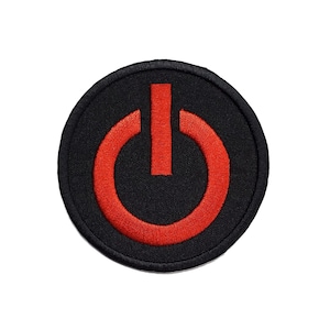May include: A black circular patch with a red power button symbol embroidered on it.