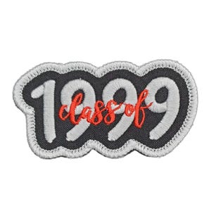 May include: A black and white embroidered patch with a white outline. The patch says "Class of 1999" in white lettering with the word "class" in red.