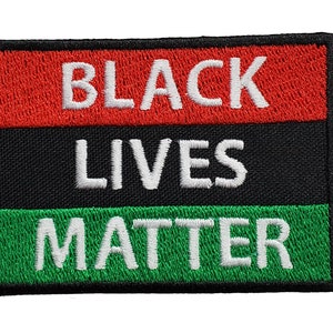 May include: Black Lives Matter patch with red, black, and green stripes. The text is white.