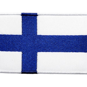 May include: A white patch with a blue cross in the centre. The patch is edged in white stitching.