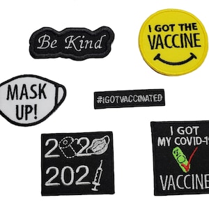 May include: A set of nine iron-on patches with various designs related to the COVID-19 pandemic. The patches feature phrases like "Be Kind", "Mask Up!" and "I Got The Vaccine".