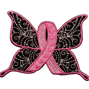 May include: Pink ribbon in the shape of a butterfly with black and silver embroidery. The ribbon has small pink hearts on it.