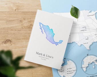 May include: A white notebook with a watercolour map of Mexico on the cover. The notebook is titled "Mark & Lisa's Wandering in Mexico June 2020".
