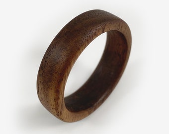 May include: A dark brown wooden ring with a smooth, polished finish.