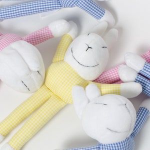 May include: Three plush bunny toys with gingham fabric. One bunny is yellow and white gingham, one is pink and white gingham, and one is blue and white gingham.