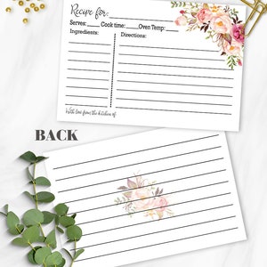 May include: White recipe cards with floral accents. The front of the card has space for recipe details, including ingredients and directions. The back features lined paper and a floral design. The text on the card reads "Recipe for" and "With love from the kitchen of."