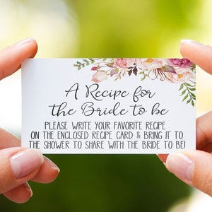 May include: A white recipe card with floral accents, held by hands. The card reads "A Recipe for the Bride to be" with instructions to share recipes at a bridal shower. The website address is visible at the top.