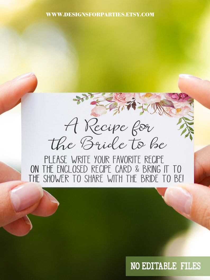 May include: A white recipe card with floral accents, held by hands. The card reads "A Recipe for the Bride to be" with instructions to share recipes at a bridal shower. The website address is visible at the top.