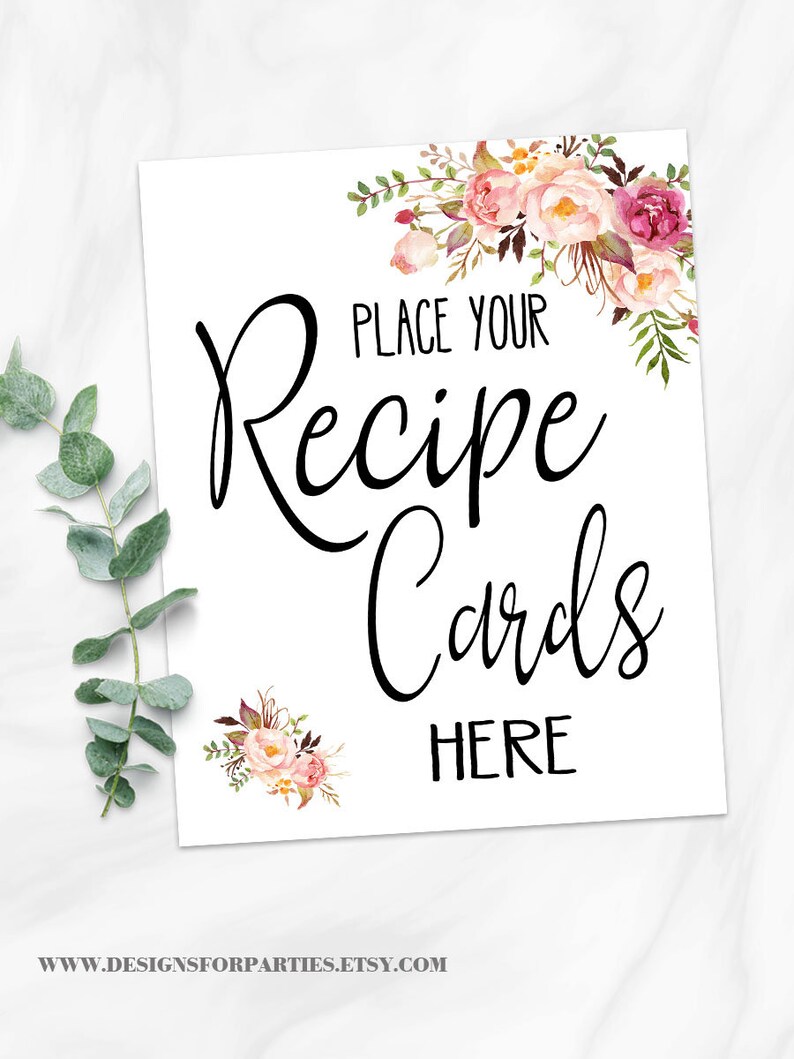 May include: White sign with the text "PLACE YOUR Recipe Cards HERE" in black script. Floral watercolor accents in pink, peach, and burgundy adorn the corners. The Etsy shop URL is at the bottom.
