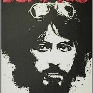 May include: A black and white poster with the title "SERPICO" in red letters. The poster features a close-up of Al Pacino's face, with a serious expression and a beard. He is wearing a pair of goggles.