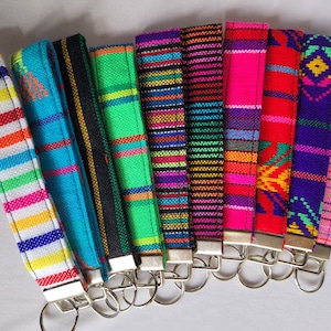 Carry your keys in style with this vibrant and eye-catching Mexican fabric wristlet keychain.