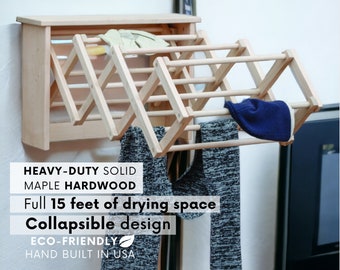 May include: A wall-mounted, wooden clothes drying rack with a collapsible design. It is made of solid maple hardwood and provides 15 feet of drying space. The rack is hand-built in the USA and is eco-friendly.