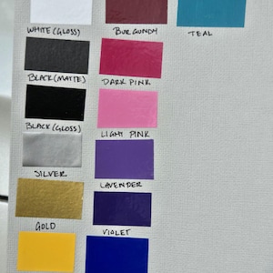 May include: A color chart featuring various hues, including white, red, blue, pink, and yellow. Each color is displayed in a rectangular shape with its name labeled below, such as "White (Matte)", "Red", and "Gentian Blue".