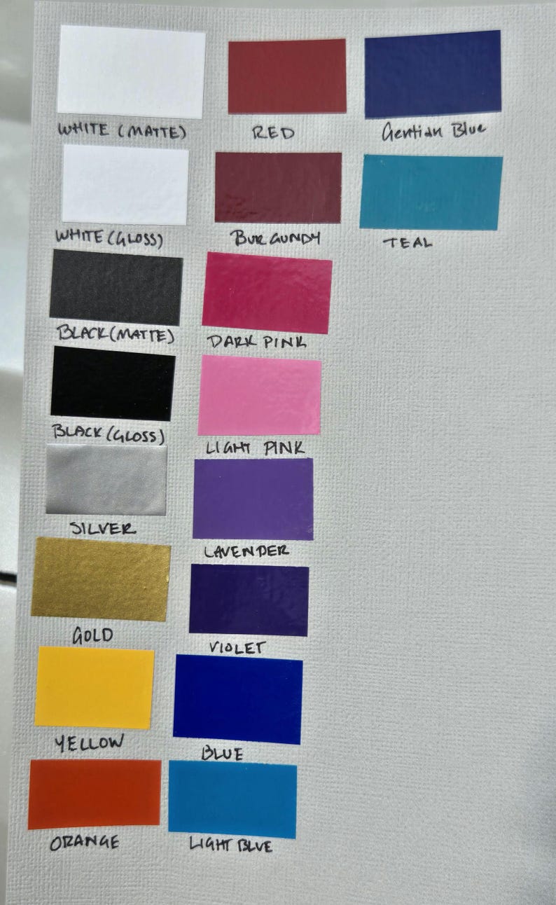 May include: A color chart featuring various hues, including white, red, blue, pink, and yellow. Each color is displayed in a rectangular shape with its name labeled below, such as "White (Matte)", "Red", and "Gentian Blue".