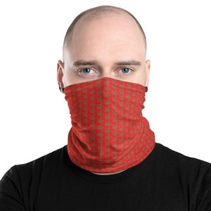 May include: A red face covering with a repeating pattern of green cannabis leaves. The neck gaiter is worn by a person with a shaved head and black shirt. The face covering is a tube-shaped design.
