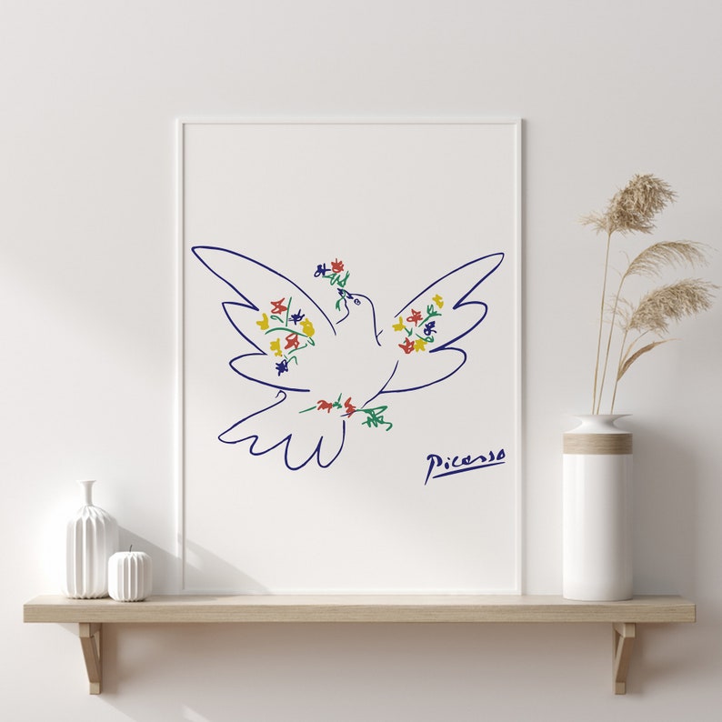 May include: A white dove with blue outline, decorated with colorful flowers, flies with wings outstretched. The dove is a line drawing by Pablo Picasso, with his signature below the dove.