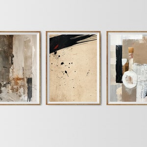 May include: Three framed abstract paintings with a neutral color palette of beige, brown, black, and white. The paintings feature geometric shapes, brushstrokes, and splatters of paint.