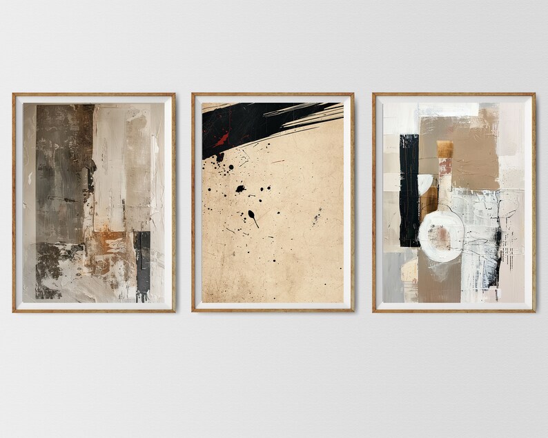 May include: Three framed abstract paintings with a neutral color palette of beige, brown, black, and white. The paintings feature geometric shapes, brushstrokes, and splatters of paint.