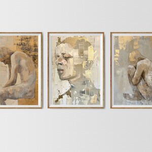 May include: Three framed paintings with a gold background and a nude figure in each. The figures are in different poses, one is sitting, one is standing, and one is curled up.