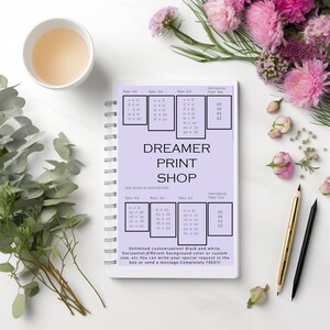 May include: A purple notebook with a size guide for prints in centimeters. The notebook has the words "DREAMER PRINT SHOP" in white text. The size guide includes different ratios and international paper sizes.