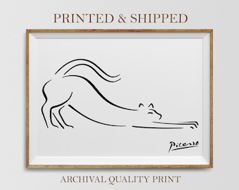 May include: Black and white line drawing of a cat stretching, signed "Picasso" in the bottom right corner.  The drawing is framed in a light wood frame.