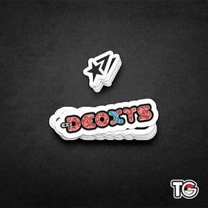 May include: A stack of white stickers with a red, blue, and white graphic of the word "Deoxys" and a black star sticker.