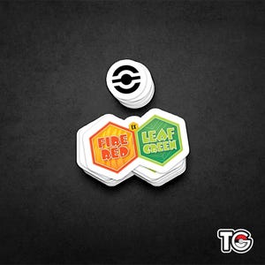 May include: A stack of white stickers with the Pokemon logo, Fire Red and Leaf Green logos, and the text "EX".