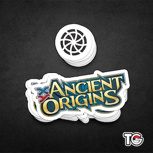 May include: A stack of white stickers with a blue and gold logo that says "Ancient Origins" and a smaller red and blue logo with an "X" in the center. The stickers are on a black background.