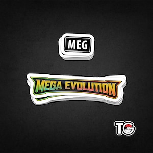 May include: A stack of white stickers with black borders. The top sticker reads "MEG" in a bold font. Below, a larger sticker displays "MEGA EVOLUTION" in a colorful, stylized design. A small sticker with "TG" and a Poké Ball logo is at the bottom.
