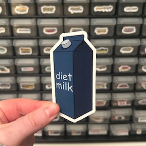 May include: A blue and white sticker of a milk carton with the text "diet milk" on the front.