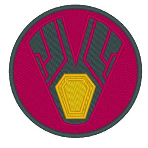 May include: A circular embroidered patch with a dark gray V-shaped design on a pink background. A yellow diamond shape is centered within the V.