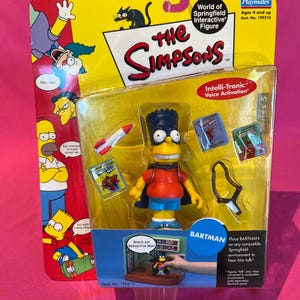 May include: A Bartman action figure from The Simpsons, packaged in a clear plastic case. The figure is yellow with a blue mohawk, red shirt, and blue shorts. The packaging includes the words "The Simpsons" and "Bartman."